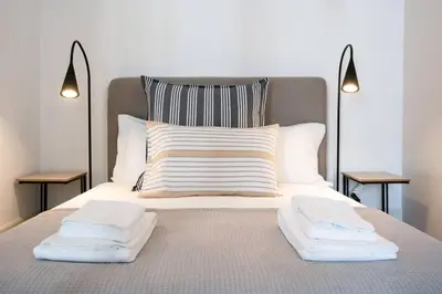 a bed with two towels on top of it at Amy Porto in Porto
