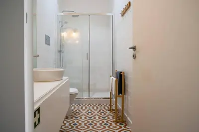 a bathroom with a shower and a sink and a toilet at Amy Porto in Porto