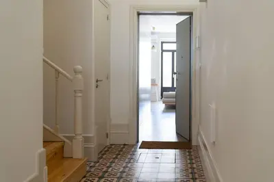 a hallway with a door leading to a living room at Amy Porto in Porto
