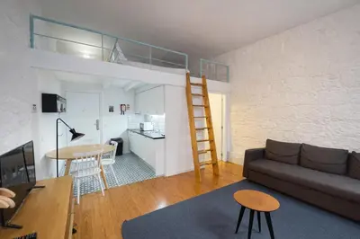 a living room and kitchen with a loft bed at Oporto City View - Trindade in Porto