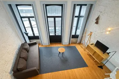 a living room with a couch and a table at Oporto City View - Trindade in Porto