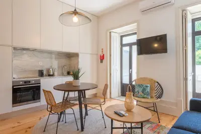 a kitchen and living room with a table and chairs at Sweety Balcony Porto Center in Porto