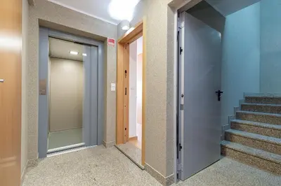 a corridor of a building with a door and stairs at Feel Porto Corporate Housing Marquês in Porto