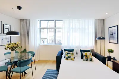 a bedroom with a large bed and a glass table at HM - Sta. Catarina Charming Apartment in Porto