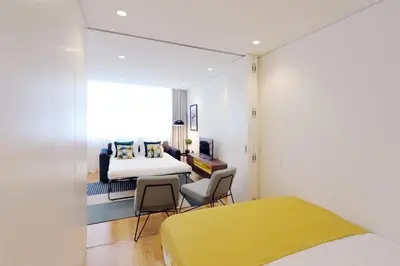 a bedroom with a bed and a table and chairs at HM - Sta. Catarina Charming Apartment in Porto
