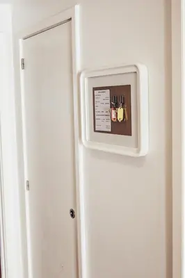 a microwave hanging on a wall next to a door at Spot Apartments in Porto