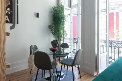 a room with chairs and a table and a window at Cinema Luxury House in Porto