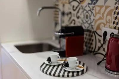 two coffee cups on a towel on a kitchen counter at Cinema Luxury House in Porto