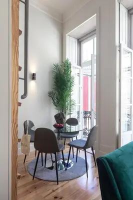 a living room with chairs and a table with a plant at Cinema Luxury House in Porto