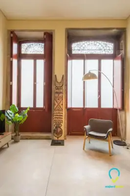 a room with two doors and a chair and a lamp at Pretty Porto in Porto