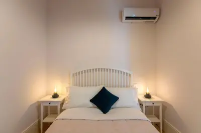 a bedroom with a bed with two night stands at LovelyStay - 2BR Flat with AC in Duque de Loulé in Porto