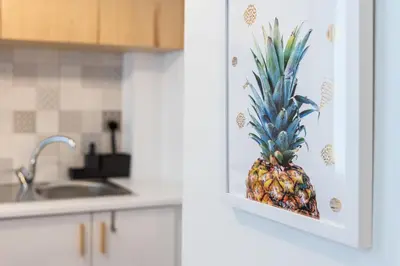 a pineapple in a cabinet in a kitchen at GuestReady - Yazdah Flat 3 in Porto