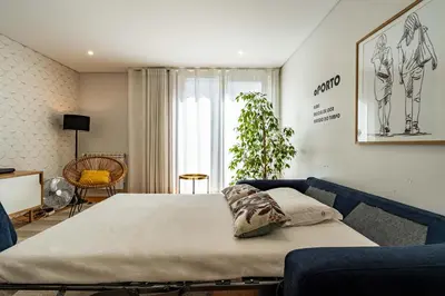 a bedroom with a bed and a couch at HM - Vagus Oporto House in Porto