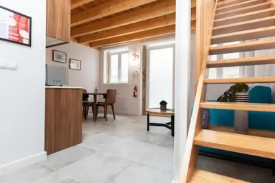 a living room with a staircase and a table at TMH Torrinha in Porto