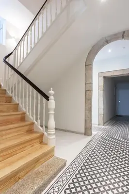a staircase in a house with white walls and wooden floors at Swimming Pool Luxury House 1 in Porto