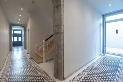 a hallway with a tile floor and a glass door at Swimming Pool Luxury House 1 in Porto