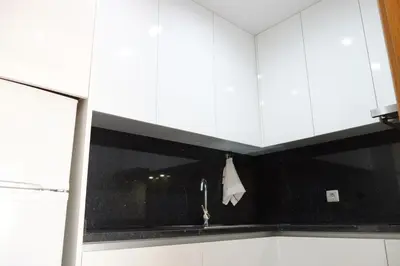 a kitchen with white cabinets and a sink at Porto River Sunset 7th in Vila Nova de Gaia