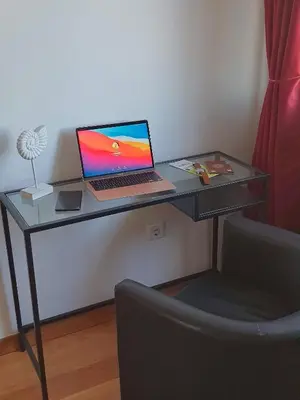 a desk with a laptop computer on it with a chair at Porto River Sunset 7th in Vila Nova de Gaia