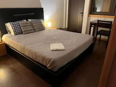a bedroom with a bed with a towel on it at Invicta House Gold in Porto