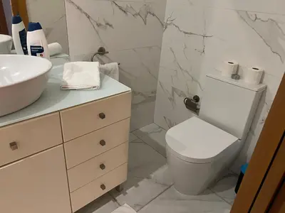 a white bathroom with a toilet and a sink at Invicta House Gold in Porto