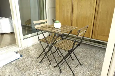 a wooden table with a chair and a potted plant at Porto River Sunset 1st in Vila Nova de Gaia