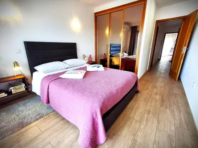 a bedroom with a large bed with a pink blanket at Porto River Sunset 1st in Vila Nova de Gaia