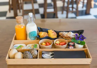a wooden tray filled with food and a bottle of milk at Oporto Comfort Dom Hugo - Historic Apartments in Porto