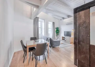 a dining room with a table and chairs at Oporto Comfort Dom Hugo - Historic Apartments in Porto
