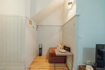 a small room with a bed and a desk at Cozy Flat with Terrace by Hosty in Porto