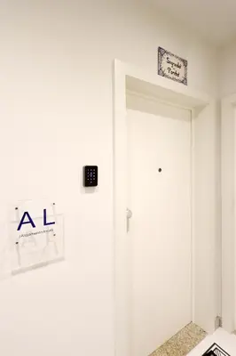 a room with a white door and a sign on the wall at HM - Segredo do Porto in Porto