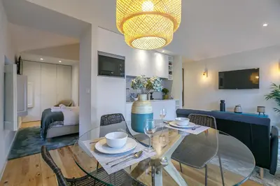 a dining room with a glass table and chairs at LovelyStay - Downtown Studio with Pool, AC and Balcony in Porto