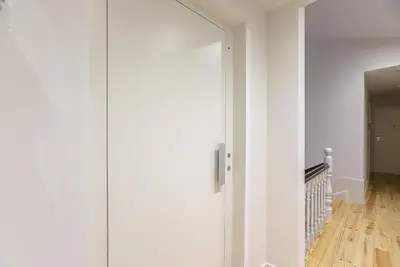 a hallway with white walls and a white door at LovelyStay - Downtown Studio with Pool, AC and Balcony in Porto
