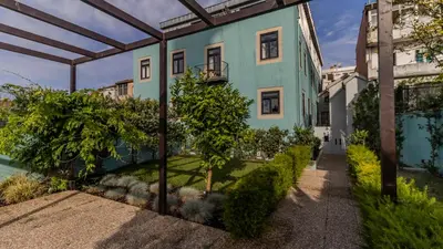 an exterior view of a building with a garden at LovelyStay - Downtown Studio with Pool, AC and Balcony in Porto