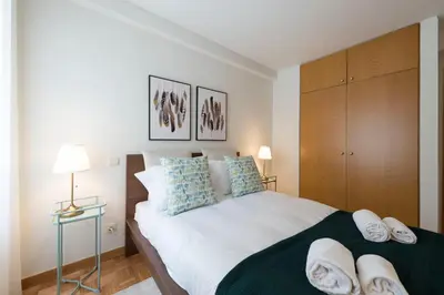 a bedroom with a large bed with towels on it at Rua de Camões in Porto