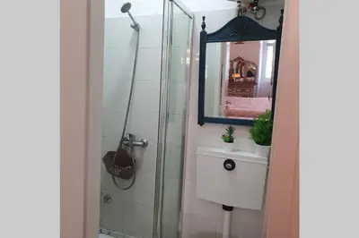 a bathroom with a shower and a sink and a mirror at Charming Clérigos Studio in Porto