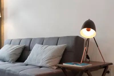 a lamp on a table next to a couch at PinPorto Downtown in Porto