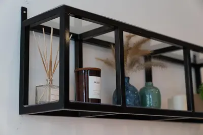a black shelf with bottles and vases on it at Clerigos Townhouse Porto by PCH in Porto