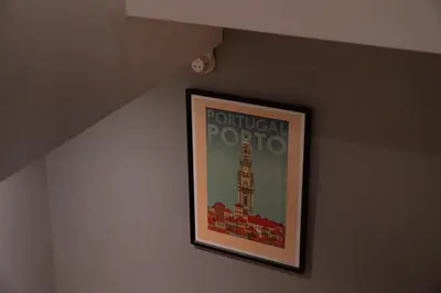 a picture on a wall with a picture of tower at Clerigos Townhouse Porto by PCH in Porto