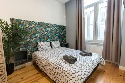 a bedroom with a bed with two towels on it at Guest H4U - Porto Fontainhas in Porto