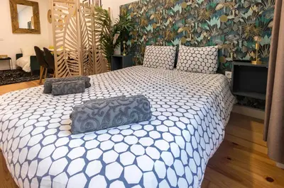 a bedroom with a large bed with two pillows on it at Guest H4U - Porto Fontainhas in Porto