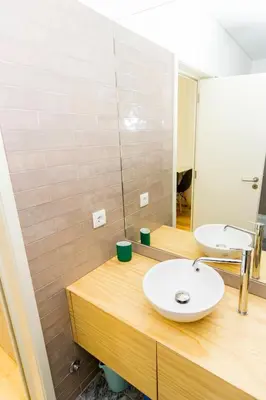 a bathroom with a sink and a mirror at Guest H4U - Porto Fontainhas in Porto