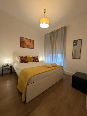 a bedroom with a large bed and a window at Beautiful Infante Apartment in Porto