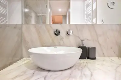 a bathroom with a white bowl sink on a marble counter at Liiiving in Porto - Santa Catarina Boutique in Porto