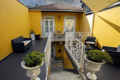 a building with a balcony with a wreath on it at Cedofeita Village Porto in Porto