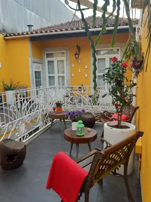 a patio with chairs and tables on a balcony at Cedofeita Village Porto in Porto