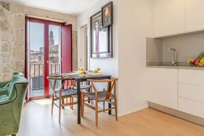 a kitchen with a table and chairs in a room at Decor Studios - Clérigos by Host Wise in Porto