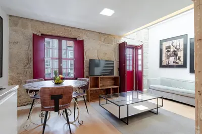 a living room with a table and a tv at Decor Studios - Clérigos by Host Wise in Porto