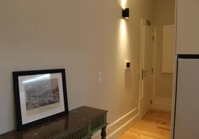 a living room with a table and a picture on the wall at Oporto Coliseum Studio in Porto