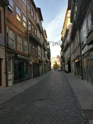 an empty street in an old town with buildings at Oporto Coliseum Studio in Porto