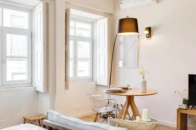 a living room with a table and chairs at DA'HOME - Boavista Green Studio in Porto